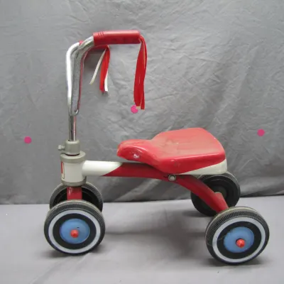 Sale Photo Thumbnail #158: Vintage red and white four-wheeled child's ride-on toy with handlebar streamers and blue wheel hubs.