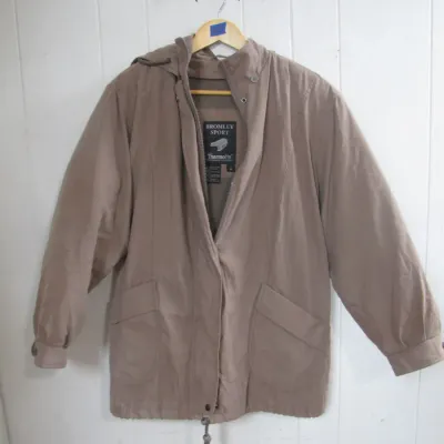 Sale Photo Thumbnail #233: Vintage Bromley Sport Thermolite insulated hooded jacket in tan, featuring a zip-and-snap closure and front pockets.