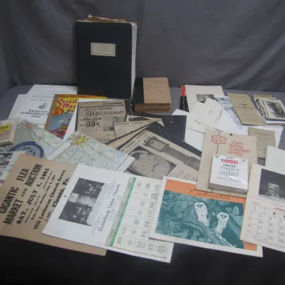 Sale Photo Thumbnail #264: Collection of vintage ephemera including 1960s and 1980s calendars, auction flyers, maps, magazines, and bound albums.