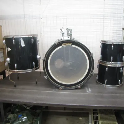 Sale Photo Thumbnail #57: Four-piece black drum shell pack featuring a bass drum with Aquarian drumhead, a floor tom, and two rack toms.