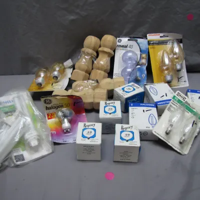 Sale Photo Thumbnail #117: Assorted lot of household light bulbs, including halogen, candelabra, and decorative options from brands like GE, Sylvania, and Regency, alongside wooden furniture finials.