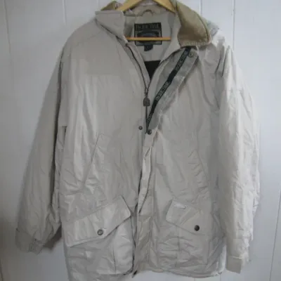 Sale Photo Thumbnail #234: Vintage Pacific Trail men's beige winter jacket with zip and snap closure, featuring a fleece-lined collar and front cargo pockets.