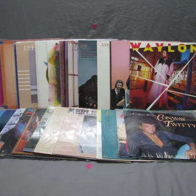 Sale Photo Thumbnail #207: Collection of classic country vinyl LP records featuring artists such as Waylon Jennings, Conway Twitty, and Merle Haggard.