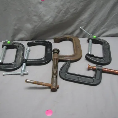 Sale Photo Thumbnail #61: Assortment of vintage and modern C-clamps in various sizes and finishes, showing light wear and surface patina.