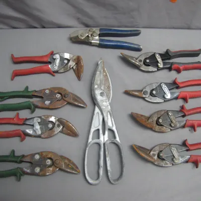Sale Photo Thumbnail #22: Collection of ten vintage and modern aviation snips and sheet metal shears showing surface rust and wear.