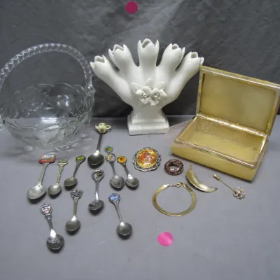 Sale Photo Thumbnail #208: Collection of decorative collectibles including a clear glass basket, a white ceramic tulip vase, an alabaster trinket box, and an assortment of souvenir spoons and costume jewelry.