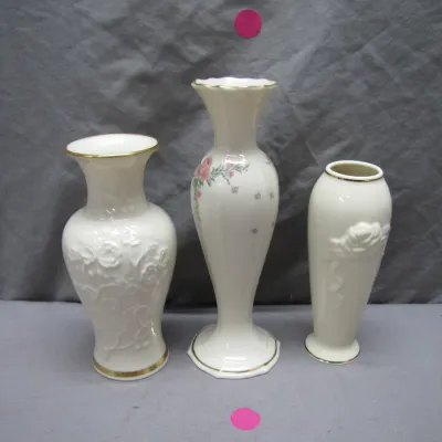 Sale Photo Thumbnail #99: Trio of Lenox porcelain bud vases featuring gold trim, floral relief accents, and painted pink rose details.