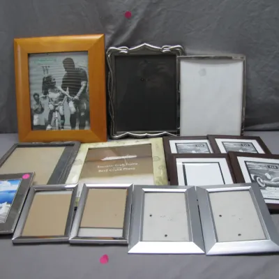 Sale Photo Thumbnail #212: Collection of assorted picture frames in modern wood, silver-tone metal, and decorative finishes.