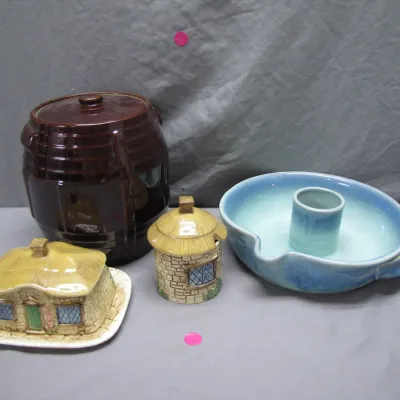 Sale Photo Thumbnail #156: Collection of vintage decorative ceramics including a cottage-style butter dish and mustard pot, a dark brown barrel cookie jar, and a light blue glazed dish.