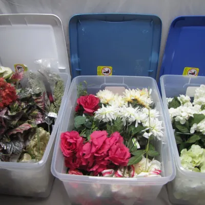 Sale Photo Thumbnail #52: Three large plastic storage bins filled with assorted faux floral stems, including hydrangeas, roses, and daisies in various colors.