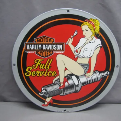 Sale Photo Thumbnail #284: Round metal Harley-Davidson Full Service pin-up girl sign, featuring a pin-up seated on a spark plug with a wrench.