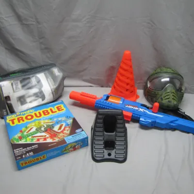 Sale Photo Thumbnail #50: Collection of assorted toys and gear, including a Pop-O-Matic Trouble board game, an X-Shot toy blaster, paintball mask, orange cone, and Everlast training gloves in a mesh bag.