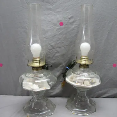 Sale Photo Thumbnail #111: Pair of vintage clear glass electric hurricane-style table lamps, featuring bases filled with sand and seashells.