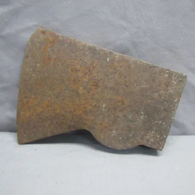 Sale Photo Thumbnail #167: Vintage rusted iron axe head showing heavy surface patina and wear.