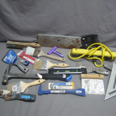 Sale Photo Thumbnail #267: Assorted hand tools, paint brushes, putties knives, level, speed square, claw hammer, pry bar, and a power strip.