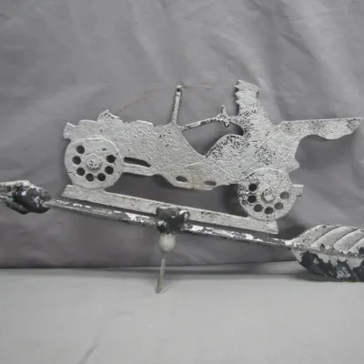 Sale Photo Thumbnail #164: Vintage painted cast iron weathervane topper featuring an antique automobile with a driver atop a directional arrow, showing chippy white paint and a weathered patina.