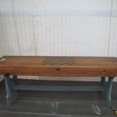 Sale Photo Thumbnail #245: Rustic wooden game bench with a painted checkerboard surface and blue painted trestle legs.