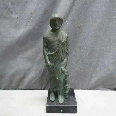 Sale Photo Thumbnail #2: Cast bronze or metal statue of Asclepius with a patinated green finish, mounted on a square black marble base.