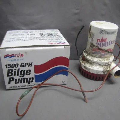 Sale Photo Thumbnail #254: Rule 2000 heavy-duty bilge pump showing heavy cosmetic wear and dirt, presented alongside an unmatching Rule 1500 GPH bilge pump box.