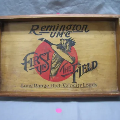 Sale Photo Thumbnail #188: Vintage Remington UMC wooden serving tray with printed goose graphics, featuring cut-out side handles and light wear.