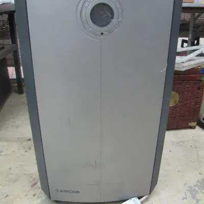 Sale Photo Thumbnail #249: Amcor portable air conditioner or dehumidifier unit in silver and dark gray finish, featuring a circular top control panel with a digital display.