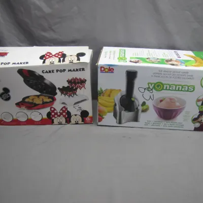 Sale Photo Thumbnail #171: Two boxed kitchen appliances, including a Disney Mickey Mouse cake pop maker and a Dole Yonanas healthy dessert maker.