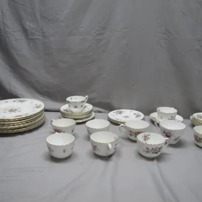 Sale Photo Thumbnail #48: Vintage fine china tea service set, featuring delicate floral patterns and gilt rims, including teacups, saucers, and dessert plates.