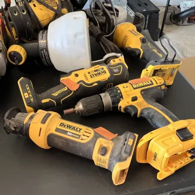 Sale Photo Thumbnail #21: Collection of used DeWalt 20V Max cordless power tools, including an oscillating multi-tool, drill driver, and reciprocating saw.