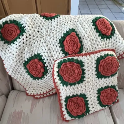 Sale Photo Thumbnail #27: Handmade crocheted rose-motif afghan throw blanket and matching accent pillow in cream, green, and terracotta red tones.