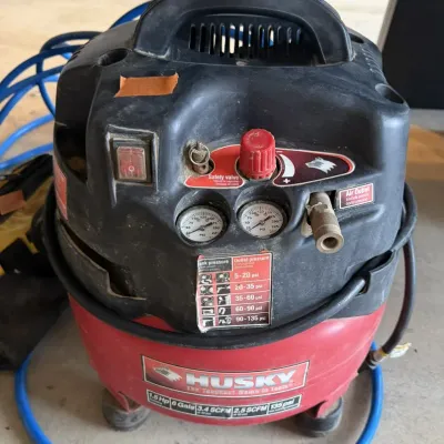 Sale Photo Thumbnail #14: Husky 1.5 HP 6-gallon pancake air compressor with attached blue hose