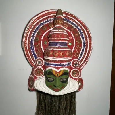 Sale Photo Thumbnail #68: Traditional Kathakali hand-painted decorative wall mask with elaborate headdress and natural fiber beard, depicting classic South Indian dance-drama iconography.