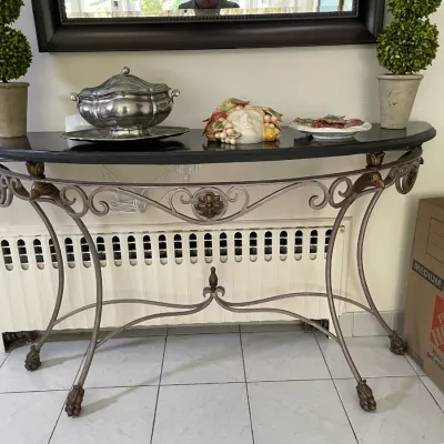 Sale Photo Thumbnail #38: Wrought iron demilune console table with a black marble top, featuring scrollwork detailing, stylized bird accents, and decorative paw feet.