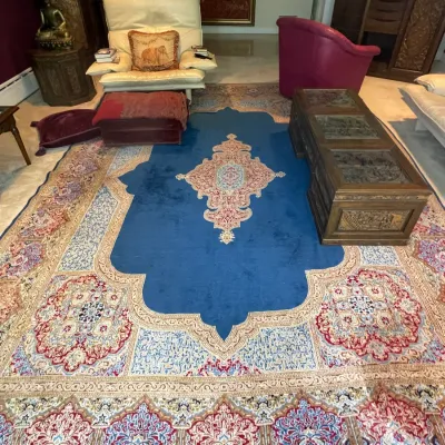Sale Photo Thumbnail #30: Large Persian-style area rug featuring a vibrant blue central field with intricate medallion and floral border patterns, displayed in a living room setting.