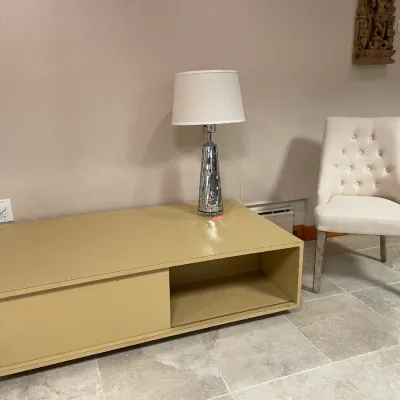 Sale Photo Thumbnail #78: Low-profile beige coffee table with an open cubby beside a beige tufted accent chair and a modern mirrored mosaic table lamp.