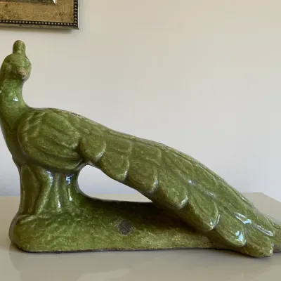Sale Photo Thumbnail #61: Mid-century green glazed ceramic peacock figurine featuring a textured tail and integrated base.
