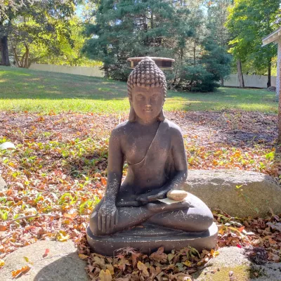 Sale Photo Thumbnail #19: Seated Buddha garden statue depicting a meditating figure in a crossed-leg pose, showing slight outdoor weathering and surface cracking.