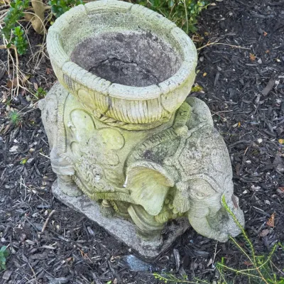 Sale Photo Thumbnail #49: Weathered concrete elephant-form garden planter with carved relief details and natural moss patina.