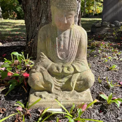 Sale Photo Thumbnail #21: Weathered concrete Buddha statue for outdoor garden decor, featuring a seated meditation pose with natural moss patina.