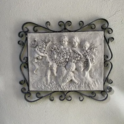 Sale Photo Thumbnail #27: Vintage plaster relief wall plaque depicting cherubs with fruit, mounted in a scrolled wrought iron frame.