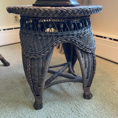Sale Photo Thumbnail #60: Victorian-style dark-stained woven wicker side table featuring intricate braided trim and decorative wood bead details.