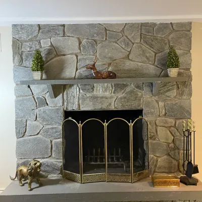Sale Photo Thumbnail #10: Mid-century brass fireplace accessories set including a folding screen, fire tools, brass lion statue, and mantel decor.