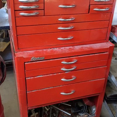 Vintage red Century brand two-piece rolling tool chest combo with top chest lid opened, featuring multiple drawers and metal handles.