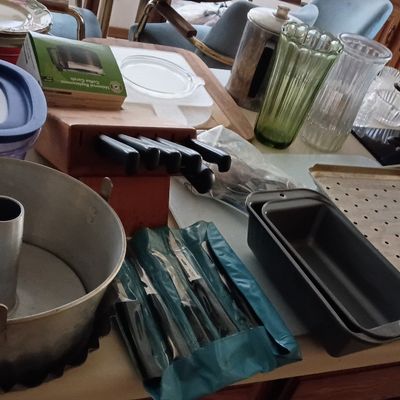 Collection of vintage kitchenware and bakeware including an aluminum angel food cake pan, loaf pans, a wooden knife block set, green...