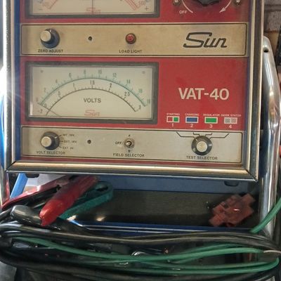 Vintage Sun Electric VAT-40 automotive volt-amp tester on a rolling cart with attached cables.