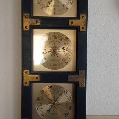 Vintage Springfield nautical-style weather station featuring a thermometer, barometer, and humidity meter set in a dark wooden frame with...