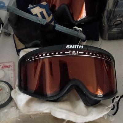 Two pairs of vintage Smith ski or tactical goggles with tinted lenses, including a Turbo Flow model and PMT Airflow model, with extra...