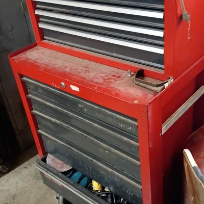 Red Craftsman two-piece rolling tool chest, featuring multiple drawers and a top chest unit.