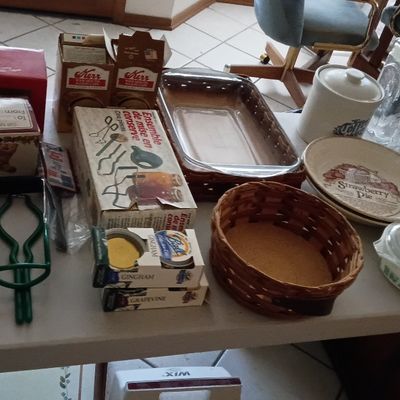 Assortment of kitchenware and canning supplies, including vintage Kerr jar boxes, Pyrex baking dish with wicker holder, decorative pie...