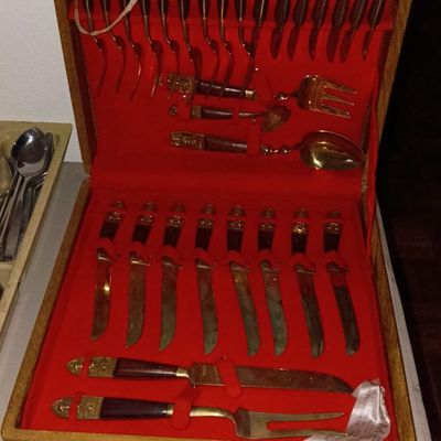 Vintage Thai bronze flatware set with wooden handles, housed in a red velvet-lined wooden storage case.