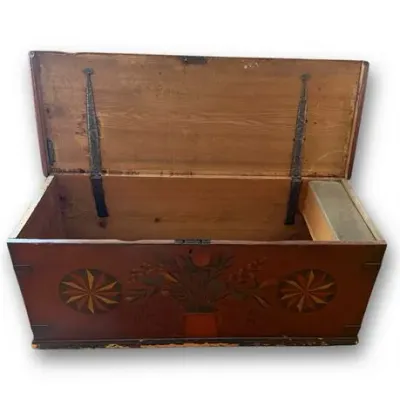 Antique hand-painted wooden trunk with a floral central motif, pinwheel side designs, and an interior till box.